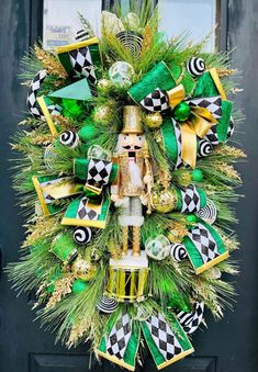 a christmas wreath with a nutcracker and green decorations on the front door to celebrate st patrick's day