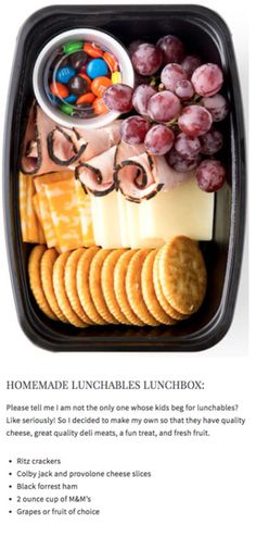 an image of a lunch box with grapes and crackers on the side, including crackers