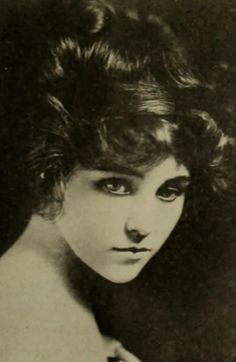 an old black and white photo of a woman