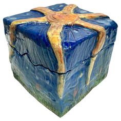 a blue and yellow box with a cross on it