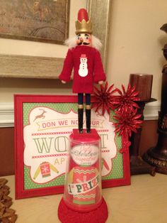 a nutcracker figurine sitting on top of a table next to a christmas card