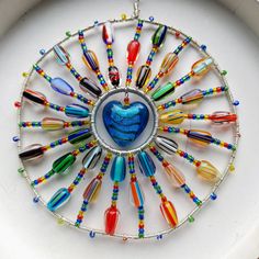 a colorful glass beaded necklace with a heart in the center