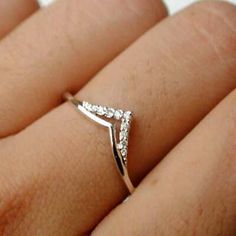 a woman's hand with a diamond ring on it