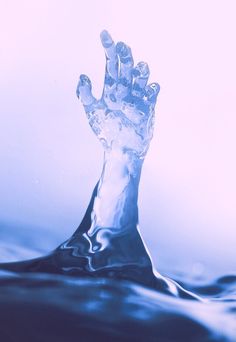 a hand that is sticking out of the water