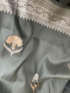 This is an exquisite katan banarasi silk saree in steel gray with beautiful kadua sona rupa motis in body and floral silver zari motifs in borders and beautiful grand zari pallu. Blouse piece is unstitched with silver zari borders. Colour may vary slightly depending upon lighting and individual device settings. Handloom products may have some irregularities  Dry clean only  All sales are final  Falls and pico are done Katan Silk Saree Banarasi, Silk Saree Banarasi, Shade Card, Saree Banarasi, Katan Silk Saree, Banarasi Silk Saree, Saree Border, Katan Silk, Contrast Blouse