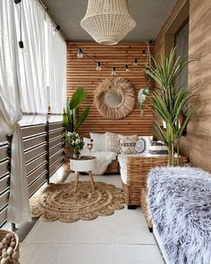 a living room filled with lots of furniture and plants on top of a wooden wall