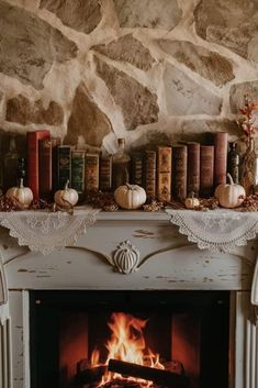 a fireplace with some books on top of it