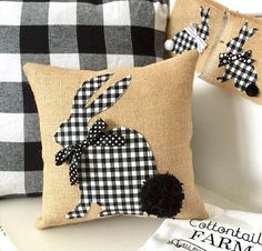 two pillows with black and white designs on them, one is made from burlock