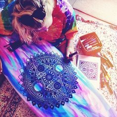 a woman laying on top of a colorful surfboard