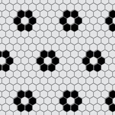 black and white hexagonal tiles are arranged in an orderly pattern on the wall