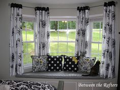 a black and white window seat with polka dot pillows