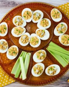 deviled eggs with celery and mayonnaise are arranged on a platter