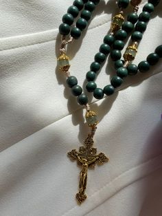 about this rosary ⬇️:  Hail Mary beads 8mm dyed wooden green beads  Our Father beads 8mm glass  beads.  Durable nylon cord  Gold tone crucifix  🌹 Say the Holy Rosary. Blessed be that monotony of Hail Mary's which purifies the monotony of your sins!"   -St. Josemaria Escriva With your rosary you'll receive a muslim reusable drawstring bag that can be used as a rosary pouch!  ⭐️ Because I use natural beads there may be a slight variations in their shape, size or colors.  ⭐️ To expand the life of your rosary beads and medal parts make sure to keep it out of moist areas. ⭐️ Exposing wooden beads for extended period of time to the sun may result in discoloration.  🫶 Follow me on instagram @promiserosaries  to be updated on new designs and sales!  NOTE: This rosary is about 14" long. Not long Green Beaded Rosary With Round Beads, Handmade Green Spiritual Rosary Bracelet, Green Beaded Rosary, Adjustable Green Rosary With Round Beads, Green Spiritual Rosary Bracelet With Round Beads, Spiritual Green Rosary Bracelet With Round Beads, Green Rosary With Round Beads As Gift, Green Beaded Spiritual Rosary Bracelet, Handmade Green Rosary As A Gift