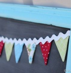 a blue frame with some red and green pennants hanging from it's sides