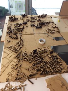 a wooden model of a city is shown on a table