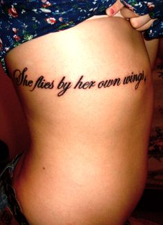 a woman's stomach with the words, she flies by her own wings