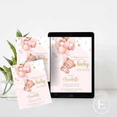 a baby shower is displayed on an ipad next to a vase with flowers in it