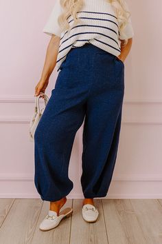 - These trendy pants are a perfect combo of cozy and cute! - Unlined tight knit material - An elastic waistline - Functional side pockets - A relaxed silhouette that ends in straight hemlines with pleated detail Navy Pants With Elastic Waistband For Loungewear, Navy Elastic Waistband Pants For Loungewear, Chic Navy Bottoms For Fall, Navy Stretch Bottoms For Fall, Stretch Navy Bottoms For Fall, Navy Bottoms For Loungewear In Winter, Cozy Fall Bottoms With Pockets, Cozy Stretch Pants With Pockets, Navy Bottoms With Pockets For Winter