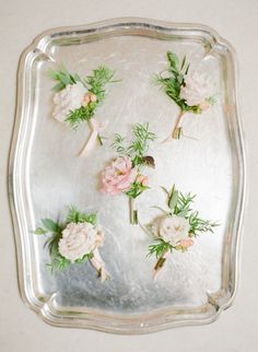 flowers are arranged on the side of a glass tray