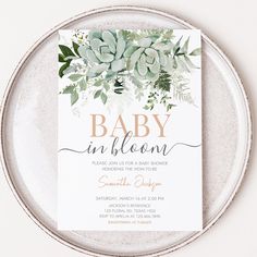 a white plate with a baby in bloom card on it