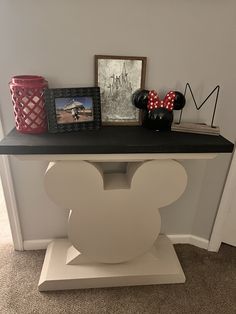 there is a mickey mouse head on the shelf