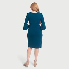 Discover the evolution of our Lisa dress! Experience the embrace of our knee-length Lisa 2.0, designed to accentuate your curves and offer dream-like comfort. With a faux wrap detail at the waist, it defines your figure for a flattering silhouette. Her deep teal hue adds a touch of sophistication, making it perfect for both daytime outings and evening events. Complete with a matching flounce, this sophisticated dress effortlessly transitions from work to play. Get ready to make it your go-to att Solid Color V-neck Faux Wrap Dress, Teal Dress By The Loft, Dark Wash V-neck Cotton Dresses, Casual Turquoise V-neck Mini Dress, Casual Turquoise V-neck Dress, Shrug Cardigan, Sophisticated Dress, The Embrace, Deep Teal