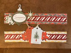 two tags are attached to the side of a brown leather surface, one has a christmas ornament on it