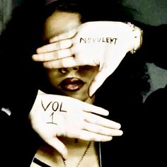 a woman holding her hands up with the words vol 1 written on their palms