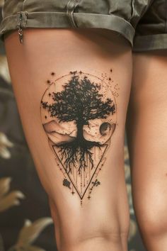 a woman's leg with a tree tattoo on it