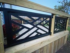 a wooden fence with black iron gates on it