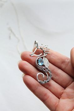 Seahorse silver neckalce with blue topaz Sterling silver | Etsy Nickel Free Ocean-inspired Pendant Jewelry, Nickel-free Ocean-inspired Pendant Jewelry, Ocean-inspired Nickel Free Pendant Necklace, Ocean-inspired Nickel-free Pendant Necklace, Silver Wire Wrapped Ocean-themed Jewelry, Silver Wire Wrapped Ocean-inspired Jewelry, Silver Ocean-inspired Wire Wrapped Jewelry, Handmade Ocean-inspired Round Pendant Jewelry, Ocean-inspired Sterling Silver Pendant Jewelry