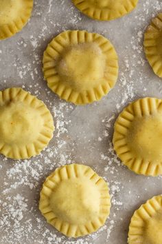 small pie crusts on a baking sheet covered in powdered sugar