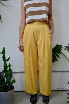 "Vintage Eighties \"Mr. Jax\" Buttercup Yellow High Waisted Trousers. Wide Leg. Pleated. Two Side Pockets. Lined. Wrap-Over Button Closure at Waist. 100% Wool Tag Size 8  Excellent Vintage Condition Waist-26\" Hips-50\" Rise-14\" Inseam-29\" All Sales Are Final. We have taken the time to note all size measurements and the condition of each piece so please look over all the information of the garment you are considering purchasing. Please note that all items are sold in \"Vintage Condition\". If Yellow Office Bottoms For Summer, Yellow Summer Office Bottoms, Classic Yellow Bottoms For Summer, Yellow Summer Bottoms With Button Closure, Yellow Formal Bottoms For Spring, Formal Yellow Bottoms For Spring, Casual Yellow Bottoms For Office, Fitted Bottoms With Buttons For Daywear, Yellow Trousers