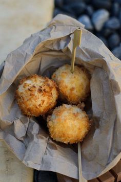 three fried food items in a paper bag