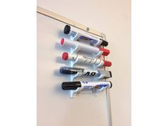 a white wall mounted shelf with several bottles on it