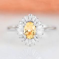 Gorgeous Vintage Inspired Halo Citrine Ring ►Made of 925 solid sterling silver with rhodium finish ►Accented with simulated diamonds (CZ) ►Average band width: 2 mm Center Stone: Citrine Shape: Oval Gem size: 5 x 7 mm Carat Weight: 1.1 ct. (approx.) Gemstone Creation: Natural Hardness: 7 (Mohs scale) ►Your sterling silver ring will not turn green itself and will not cause your skin to turn green. ►Vintage inspired ►True to size ✓ 100% Nickel-Free ✓ Hypoallergenic ✓ Comfort Fit ✓ Free Ring Box ✓ F Oval Halo Ring, Citrine Ring Engagement, Popular Engagement Rings, Yellow Jewelry, Yellow Gemstones, Gemstone Engagement, Citrine Ring, Natural Citrine, Wedding Ring Designs