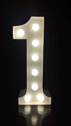 a lighted up number one sitting on top of a table