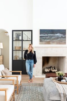 a woman is standing in the living room