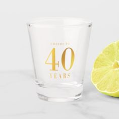 a glass with the number 30 years next to a lemon