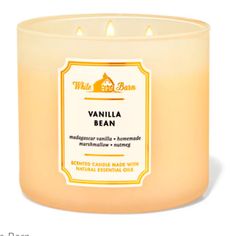 a candle that is sitting in front of a white background with the words vanilla bean on it