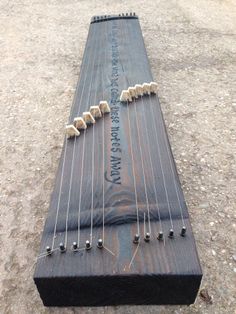 an instrument is laying on the ground with strings attached to it's back end