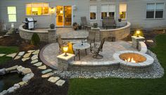 an outdoor patio with fire pit and seating area