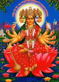 the hindu goddess sitting on top of a lotus