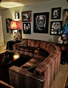 a living room filled with furniture and pictures on the wall