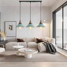 a living room filled with white furniture and lots of lights hanging from the ceiling above