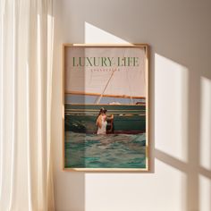 there is a poster hanging on the wall next to a window that shows a woman in a boat