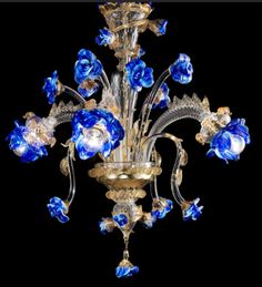 a chandelier with blue glass flowers on it