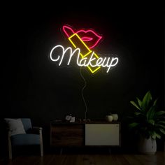 a neon sign that says makeup on it's side in front of a black wall