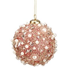 a pink ornament with pearls hanging from a chain