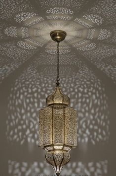 an intricately designed chandelier hangs from the ceiling